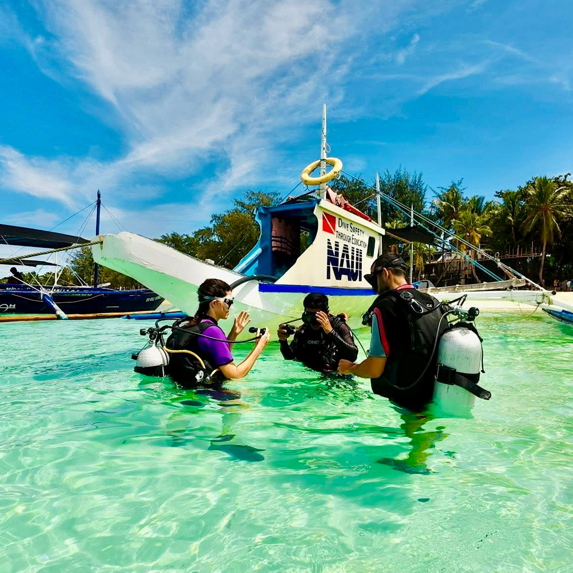 Divers with divemaster doing shallow water training